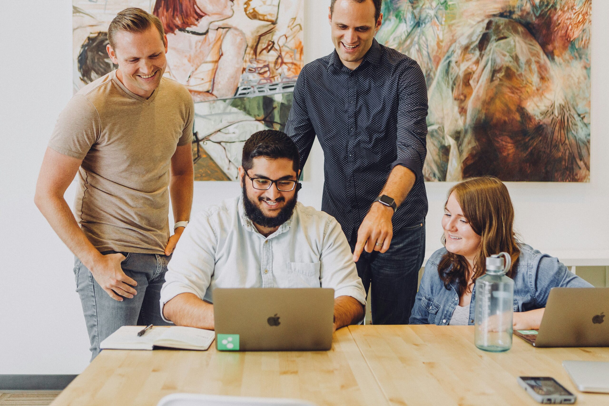 Happy business owners in front of a computer.